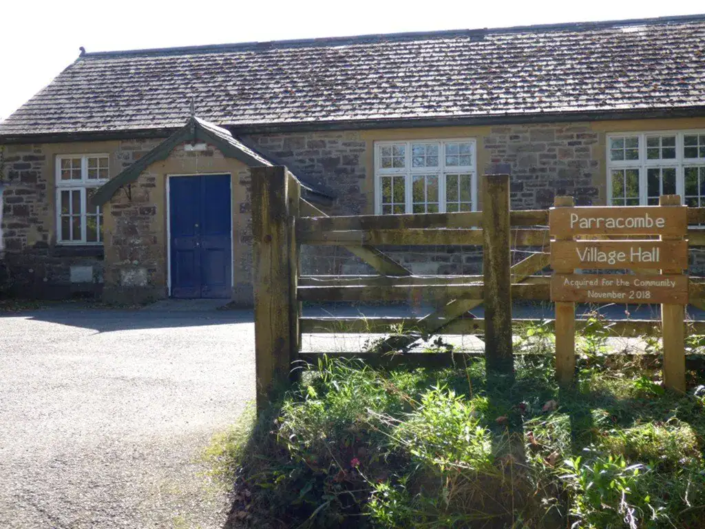 Traditional stone village hall with blue door in Parracombe, North Devon.