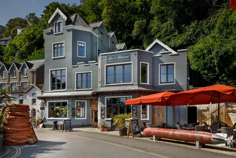 Charming seaside pub in Lynton, North Devon, featuring outdoor seating and nautical decor.