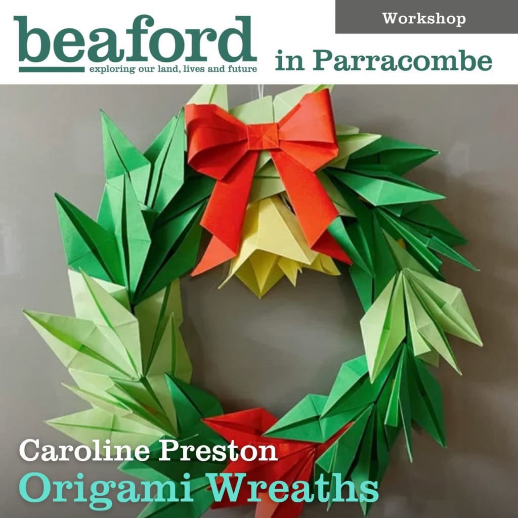 Papercraft origami Christmas wreath with green, yellow, and red folded paper leaves and a bow.