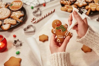 Festive gingerbread cookies and sweets on a table, ready for decorating.