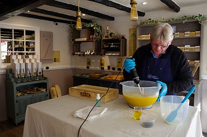 Pouring oil into a bowl in a rustic kitchen setting.
