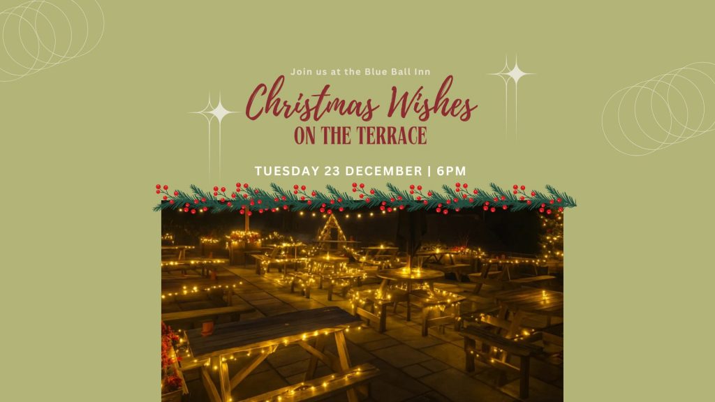 Festive terrace decorated with string lights and Christmas garlands at night.