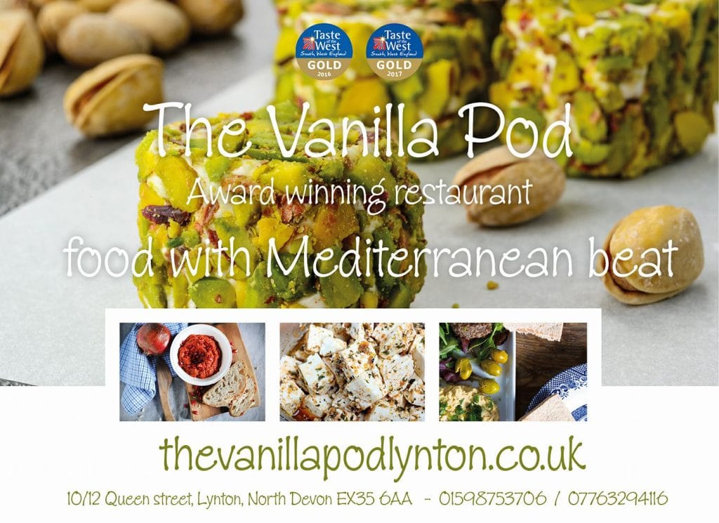 Close-up of colourful pistachio and violet dessert balls on parchment paper.