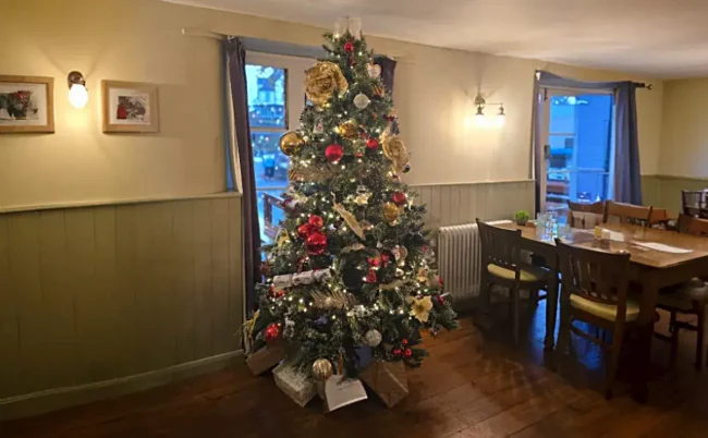 Christmas at The Crown Hotel Christmas at The Crown Hotel with a decorated tree in the dining room in Lynton