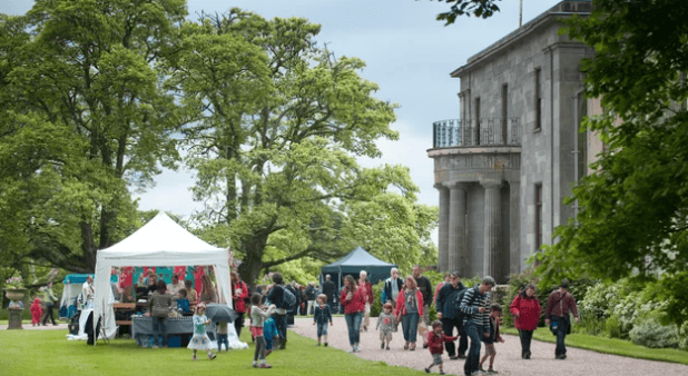 A lively outdoor fair in Lynton with tents, families, and visitors enjoying summer festivities.