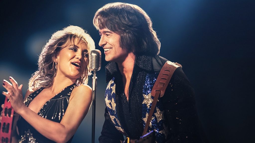 A female singer and male guitarist performing live on stage in Lynton & Lynmouth, showcasing local entertainment and musical events.