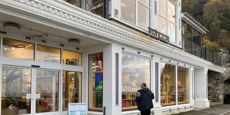 A bustling street scene in Lynton and Lynmouth with shops and visitors.