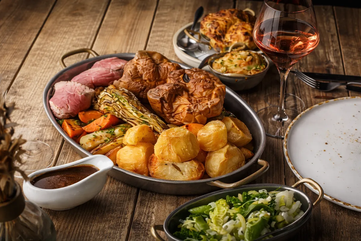 Delicious Sunday roast featuring roast beef, potatoes, vegetables, and gravy at Restaurant Kensingto.