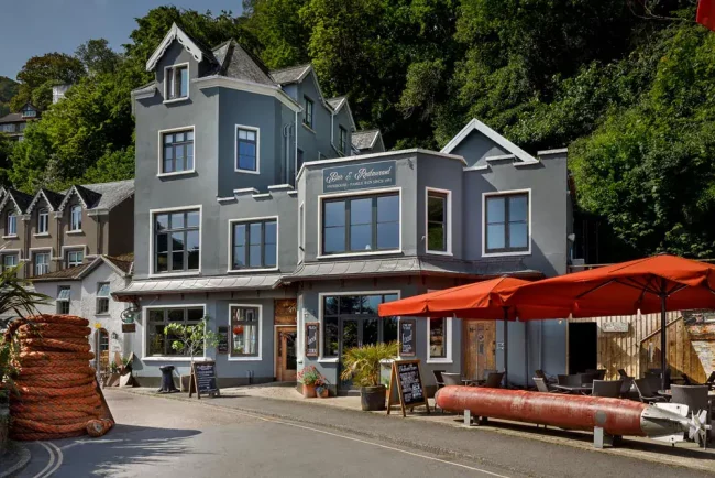 Charming seaside inn with colourful exterior and outdoor seating in Lynton, North Devon.