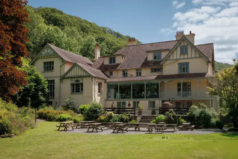 Historic manor house in Lynton with gardens and outdoor seating.